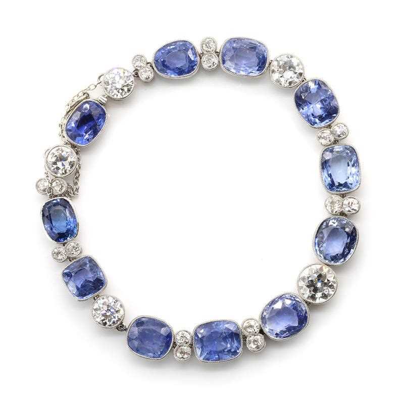 Lot 56 - A Ceylon sapphire and diamond rivière bracelet, c.1920
