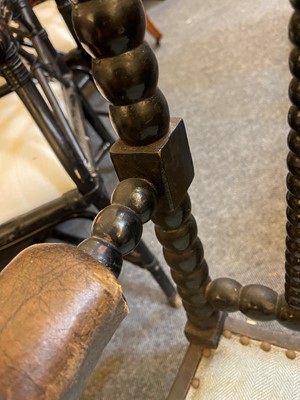 Lot 158 - An ebonised bobbin-framed nursing chair
