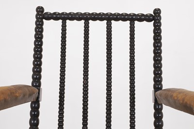 Lot 158 - An ebonised bobbin-framed nursing chair