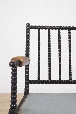 Lot 158 - An ebonised bobbin-framed nursing chair