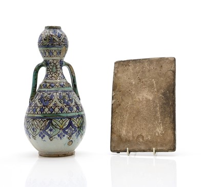 Lot 148 - A Islamic relief moulded pottery tile
