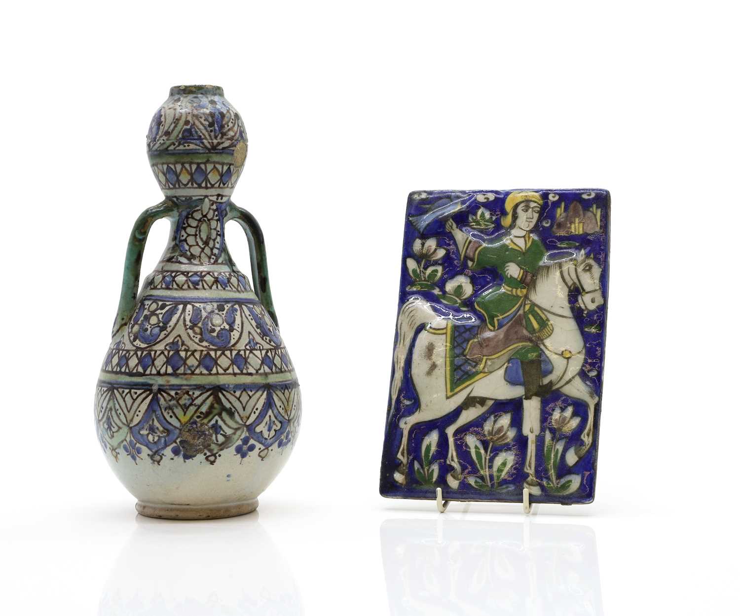 Lot 148 - A Islamic relief moulded pottery tile