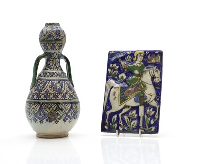 Lot 148 - A Islamic relief moulded pottery tile
