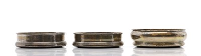 Lot 49 - A pair of silver wine bottle coasters