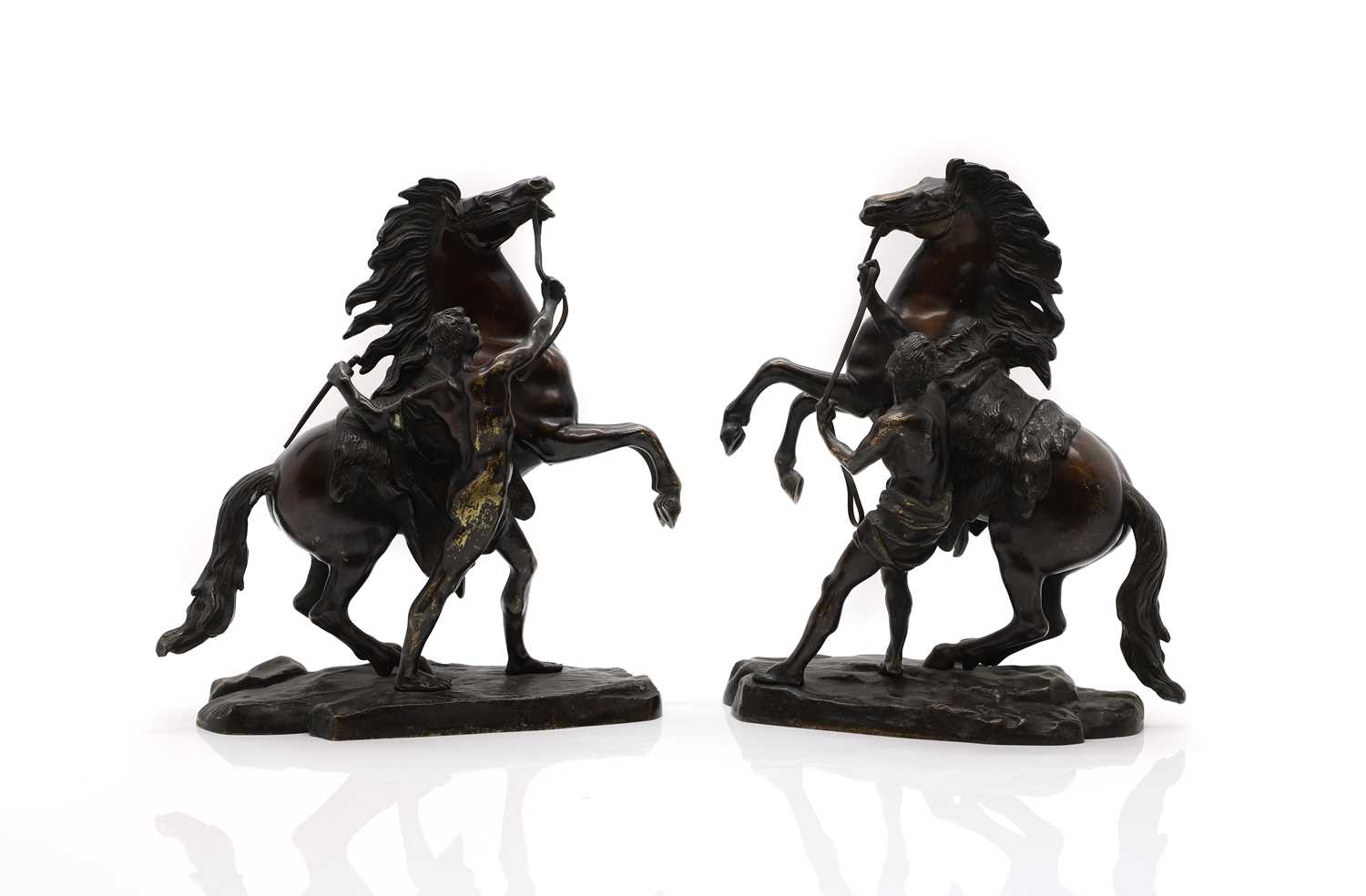 Lot 220 - A pair of patinated bronze sculptures
