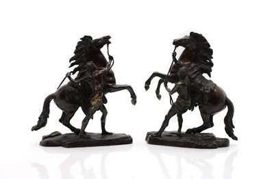 Lot 220 - A pair of patinated bronze sculptures