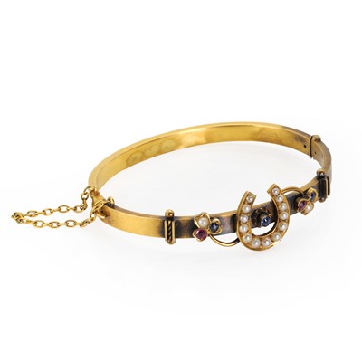 Lot 16 - A late Victorian 15ct gold horseshoe bangle
