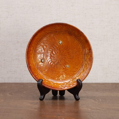 Lot 6 - A Chinese amber-glazed saucer