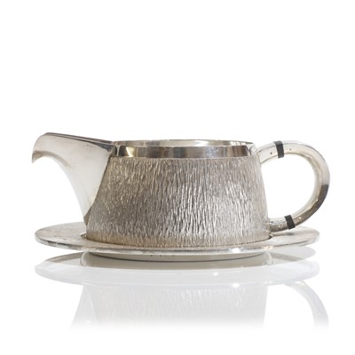 Lot 132 - A textured sterling silver cream jug