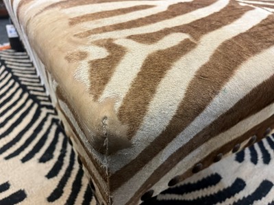 Lot 63 - A stained wood and zebra skin stool