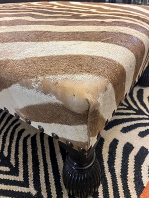Lot 63 - A stained wood and zebra skin stool