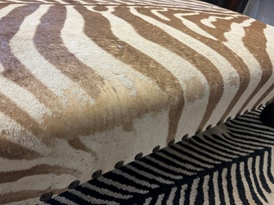 Lot 63 - A stained wood and zebra skin stool