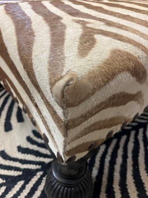 Lot 63 - A stained wood and zebra skin stool
