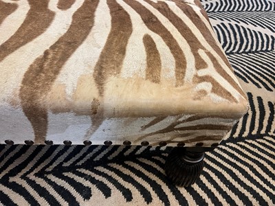 Lot 63 - A stained wood and zebra skin stool