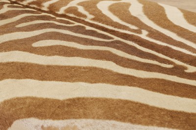 Lot 63 - A stained wood and zebra skin stool