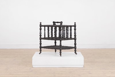 Lot 23 - An ebonised wooden magazine rack