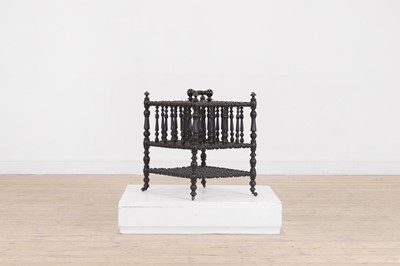 Lot 23 - An ebonised wooden magazine rack