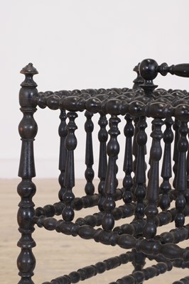 Lot 23 - An ebonised wooden magazine rack