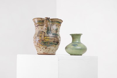 Lot 115 - A painted and glazed terracotta pitcher