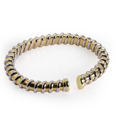 Lot 129 - An 18ct bi-colour gold torque bangle