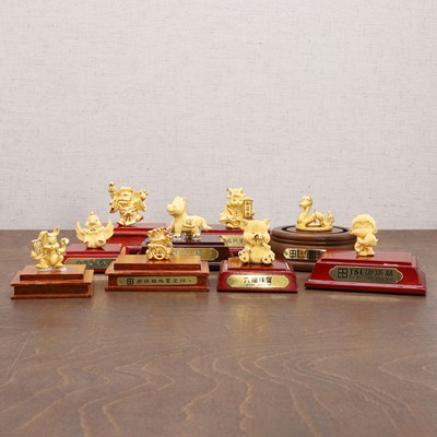 Lot 129 - A collection of nine Chinese 18ct gold figures
