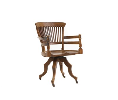 Lot 536 - An oak swivel desk chair