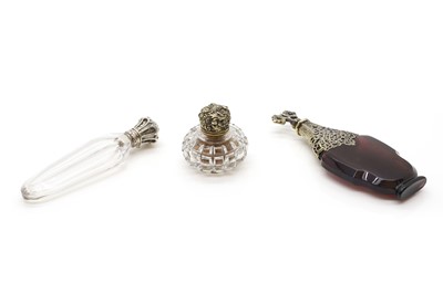 Lot 112 - A group of three silver mounted and glass scent bottles
