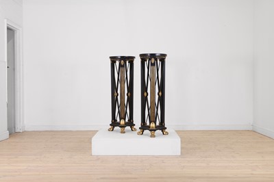 Lot 162 - A pair of Regency-style ebonised and parcel-gilt wooden pedestals