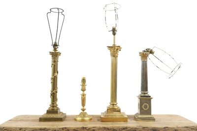 Lot 581 - A group of three brass Corinthian column lamps