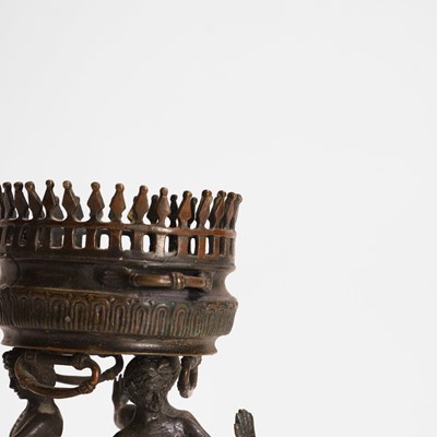 Lot 103 - A bronze tripod jardinière