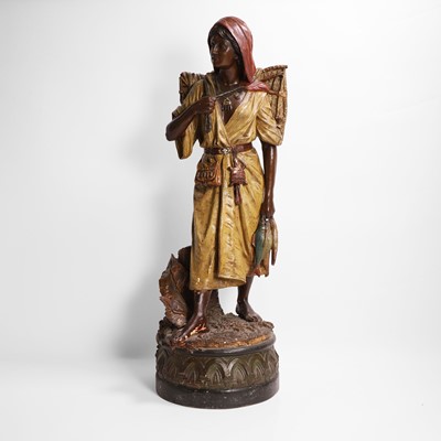 Lot 476 - A terracotta figure of a fish seller