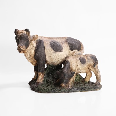 Lot 583 - A plaster figure of a cow and calf