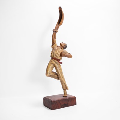Lot 571 - A carved wooden and painted figure of a pelota player