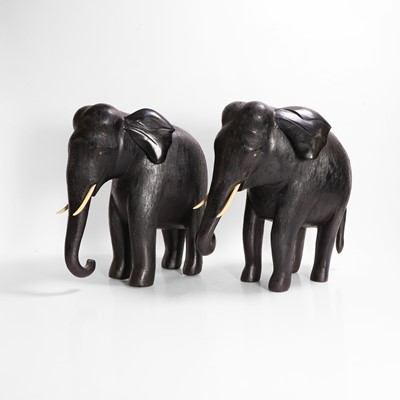 Lot 84 - A large pair of ebony and lacquered elephants