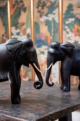 Lot 84 - A large pair of ebony and lacquered elephants