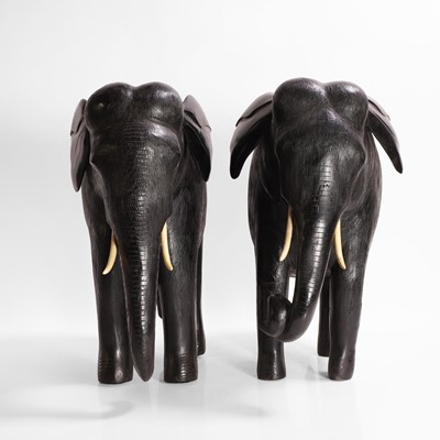 Lot 84 - A large pair of ebony and lacquered elephants