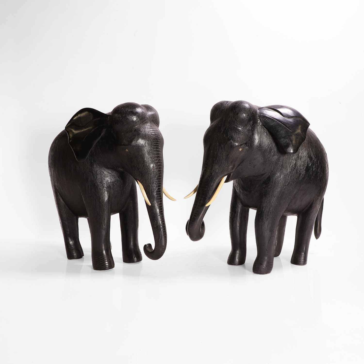 Lot 84 - A large pair of ebony and lacquered elephants