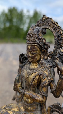 Lot 124 - A gilt-copper bodhisattva