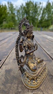 Lot 124 - A gilt-copper bodhisattva