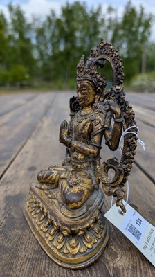 Lot 124 - A gilt-copper bodhisattva