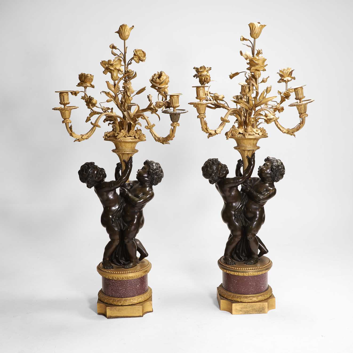 Lot 58 - A pair of large gilt-bronze, bronze, and porphyry candelabra after Jean-Louis Prieur