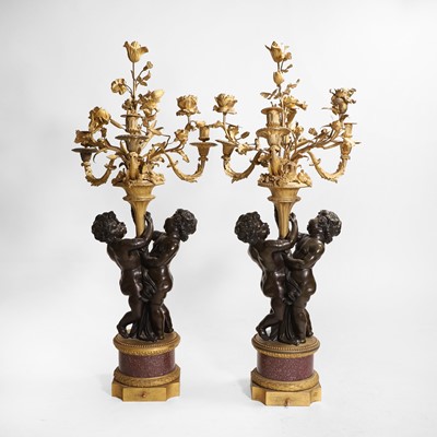 Lot 58 - A pair of large gilt-bronze, bronze, and porphyry candelabra after Jean-Louis Prieur