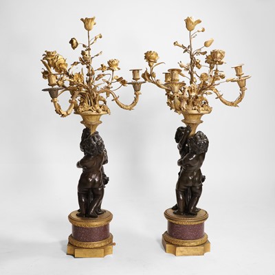 Lot 58 - A pair of large gilt-bronze, bronze, and porphyry candelabra after Jean-Louis Prieur