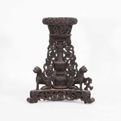 Lot 434 - A carved teak and rosewood jardinière stand