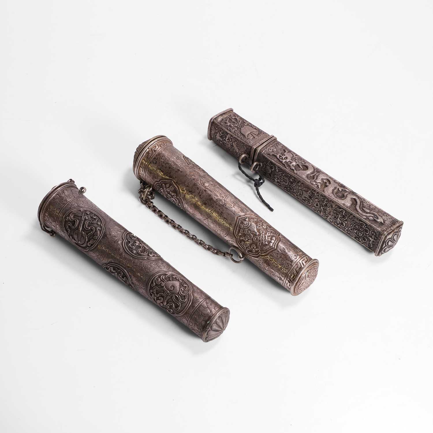 Lot 138 - Three silver scroll holders