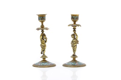 Lot 209 - A pair of ormolu and champleve figural candlesticks