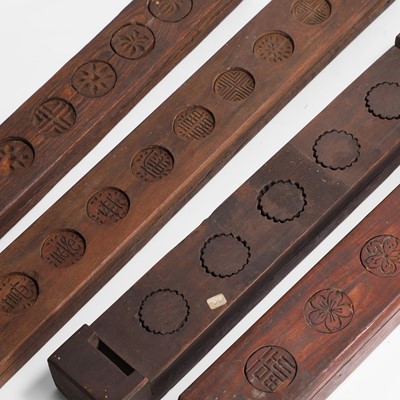 Lot 578 - A group of four carved wood rice cake moulds
