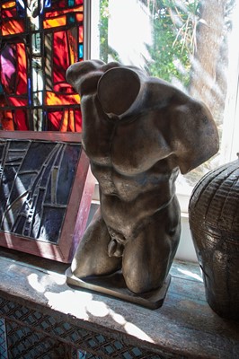 Lot 580 - A patinated plaster male torso