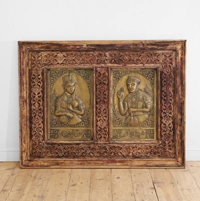 Lot 605 - A carved wooden and brass-inset panel