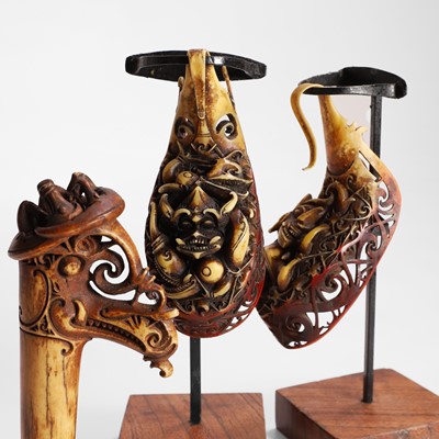 Lot 488 - Two carved hornbill ‘aso’ ear ornaments